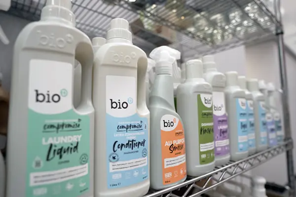 A shelf stocked with various Bio D cleaning and personal care products, organized and clearly labeled.
