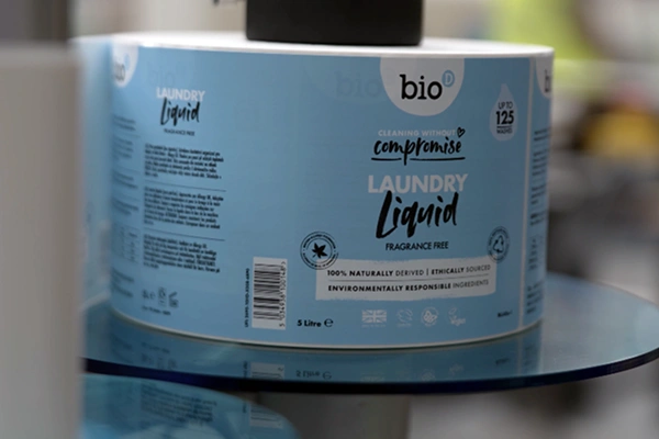 Roll of Bio-D Laundry Liquid product labels with sustainability and ethical sourcing claims.
