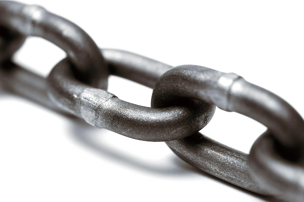 Close-up of a strong metal chain link on a white background.