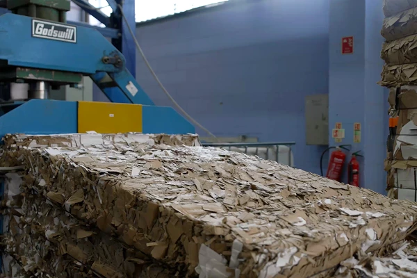 Baled paper waste prepared for recycling in an industrial facility.