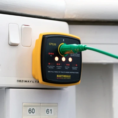 Close-up of a Martindale CP520 electrical socket tester in use, verifying outlet safety and compliance.