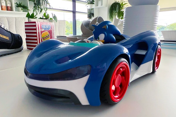 Sonic the Hedgehog toy in a blue race car displayed on a product design table.
